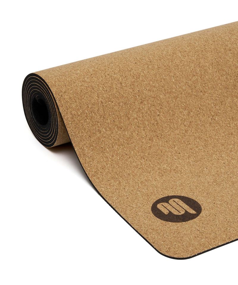  Woman using Luxe Eco Yoga Mat - Cork in a peaceful yoga studio, experiencing the natural comfort and support of the cork material